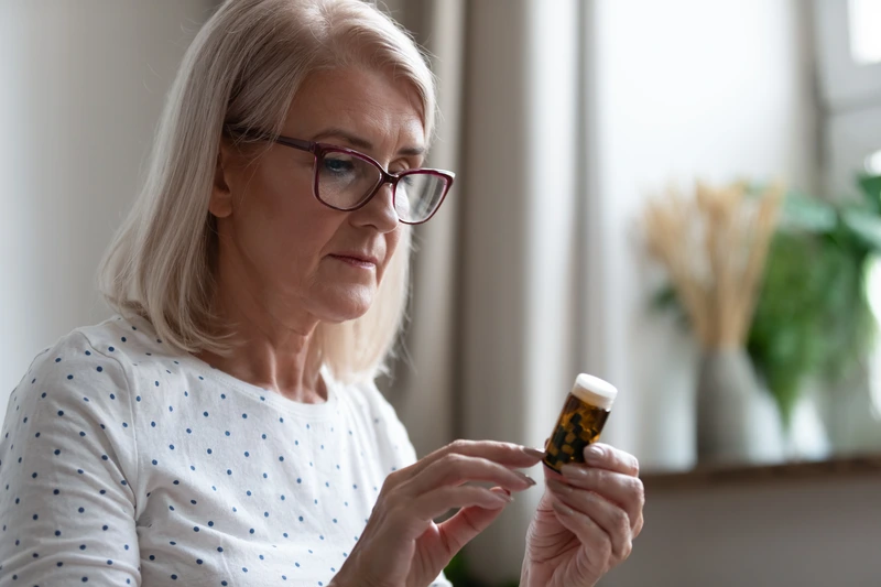 woman holding estrogen supplement