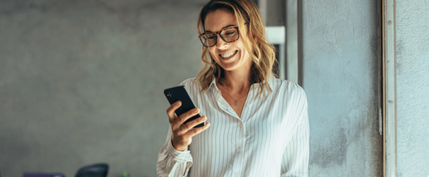 Woman smiling holding a phone