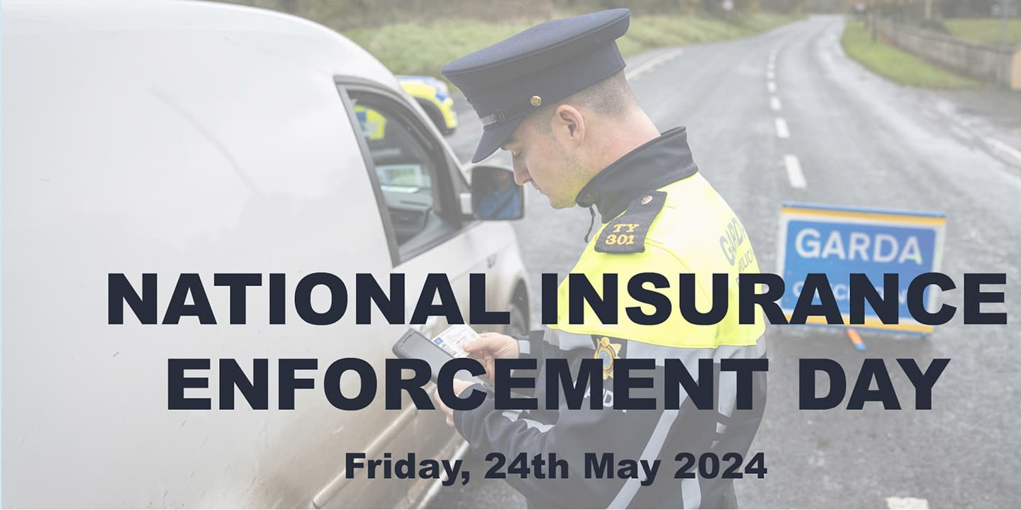 Garda checking insurance and license at checkpoint