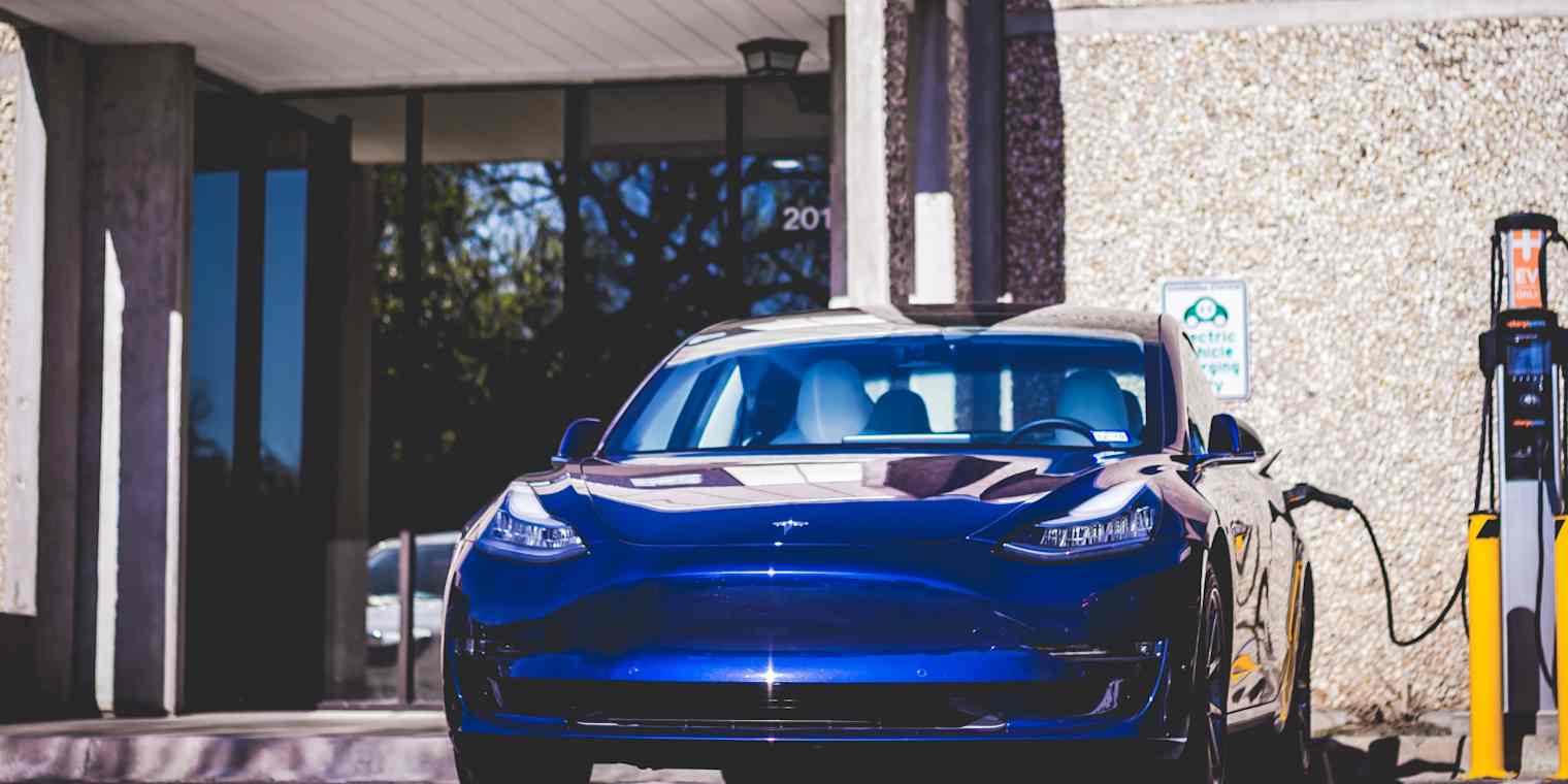 An electric car being charged by a Smart Charge America charger