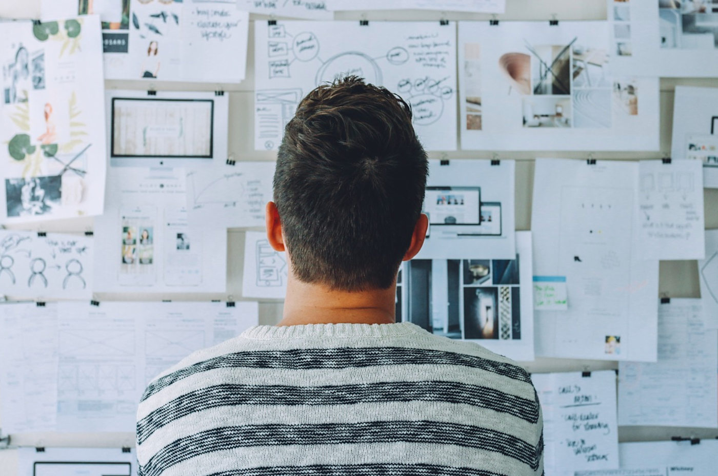 Man looking at whiteboard of ideas