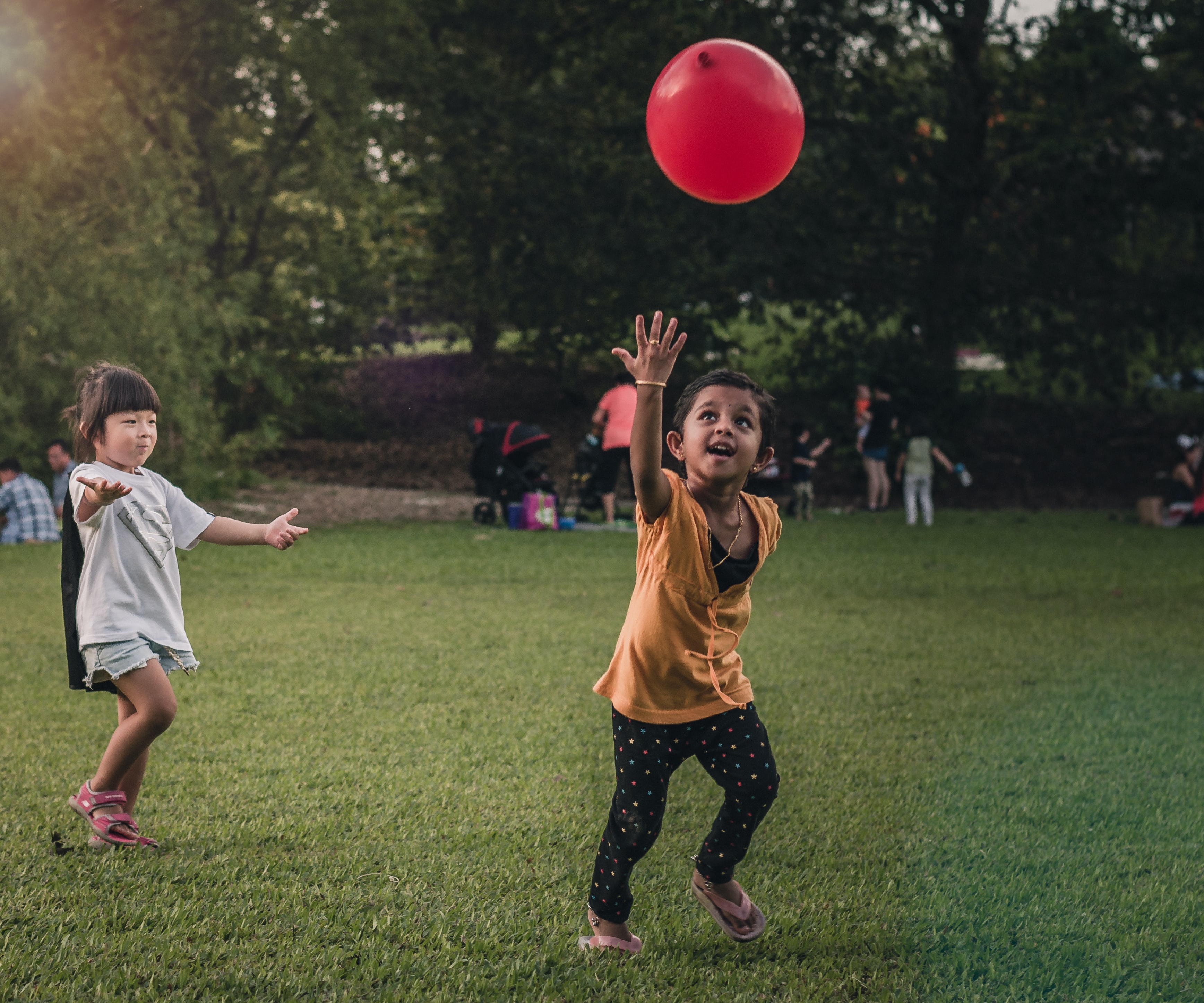 Two children playing together with a ball