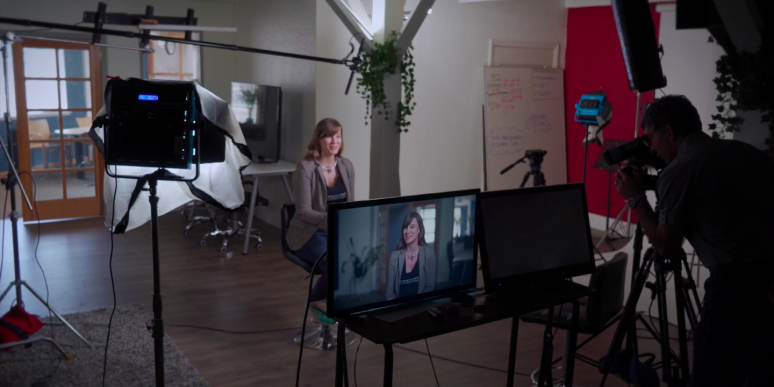 A hero image with a woman being recorded in a studio