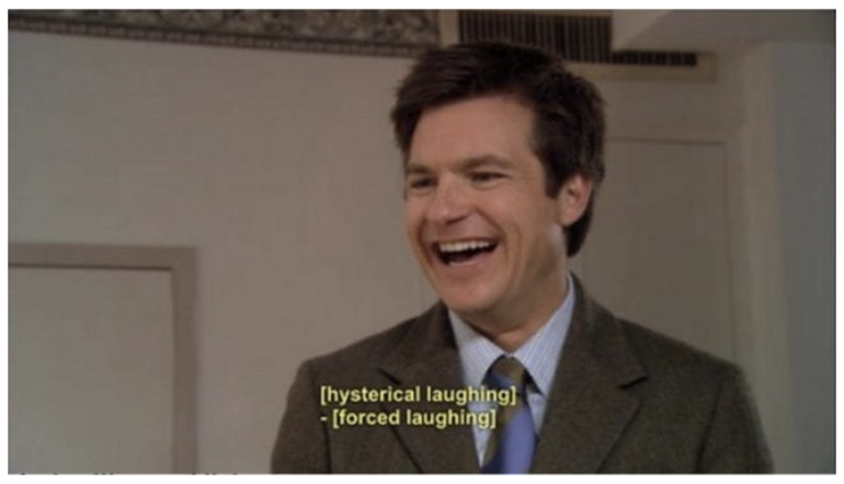 A screengrab from Arrested Development, with Michael Bluth (a man in a suit) laughing. The words on the screen say "[hysterical laughing] [forced laughing]"