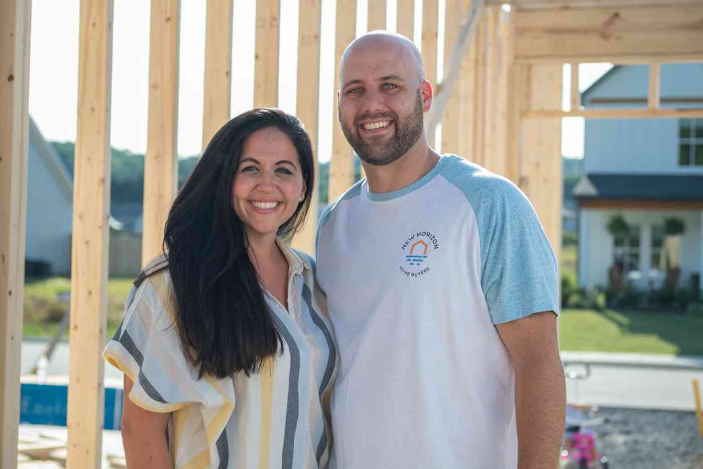 Jessica and Erik Wright stand in a home that is under construction.