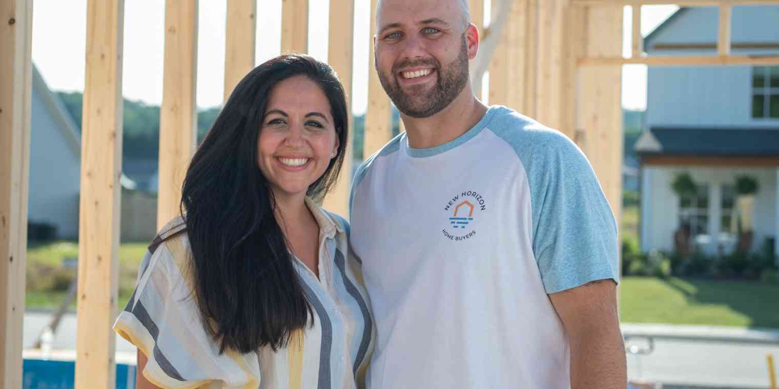 Jessica and Erik Wright stand in a home that is under construction.