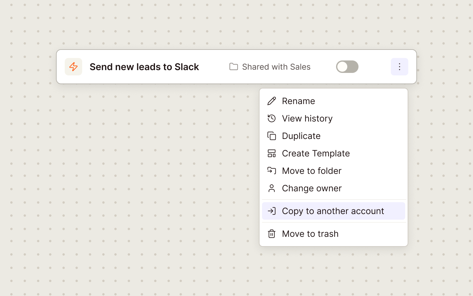 Illustration of the Send new leads to Slack Zap row, toggle off, in Shared with Sales, with its menu open: Rename, View history, Duplicate, Create Template, Move to folder, Change owner, Copy to another account highlighted, Move to trash.