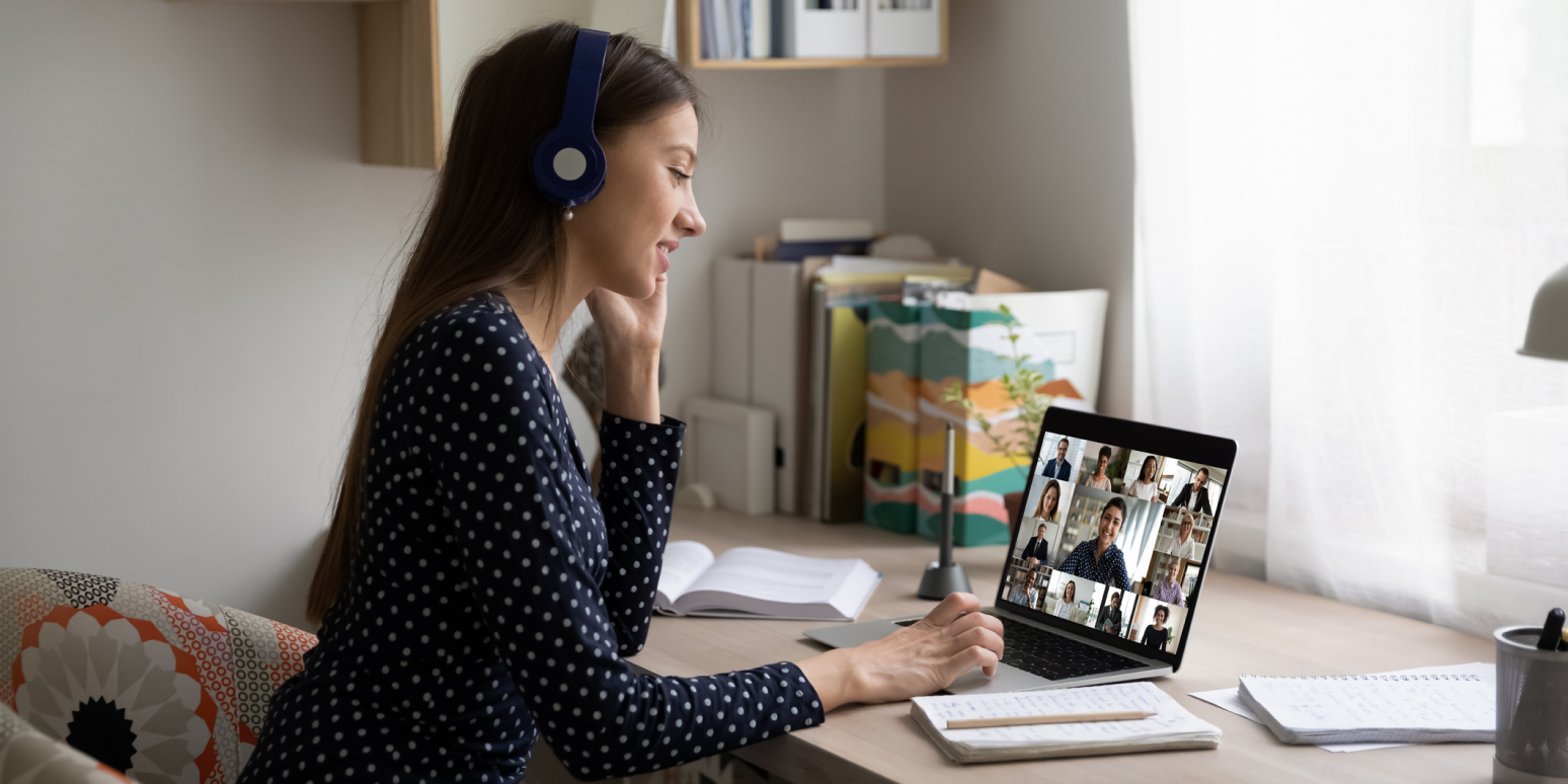 Hero image of a woman with a headset on a video conferencing call