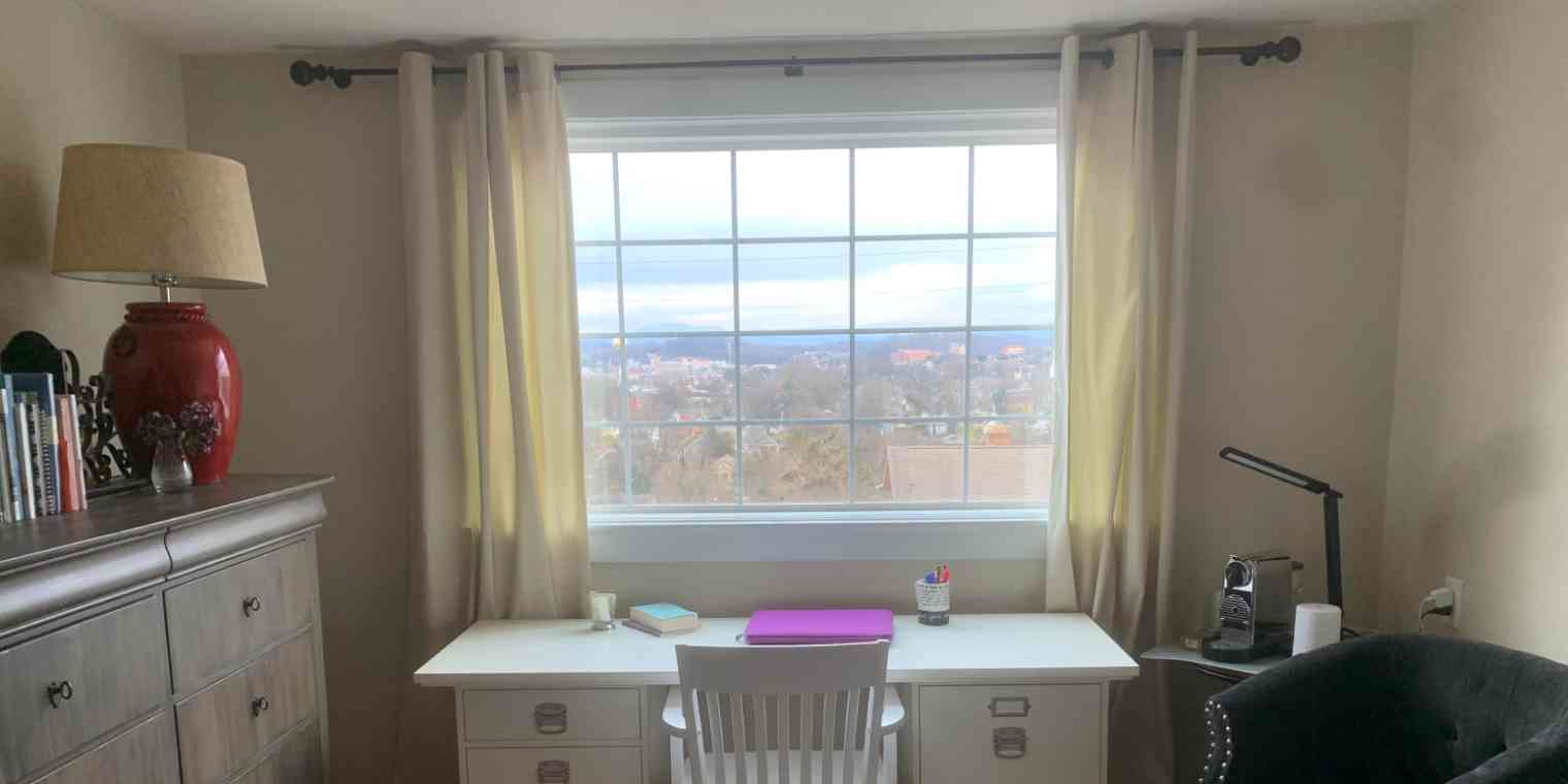 A hero image of a desk in front of a bedroom window