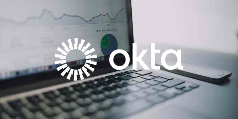 A zoomed-in image of a laptop screen with the Okta logo over it