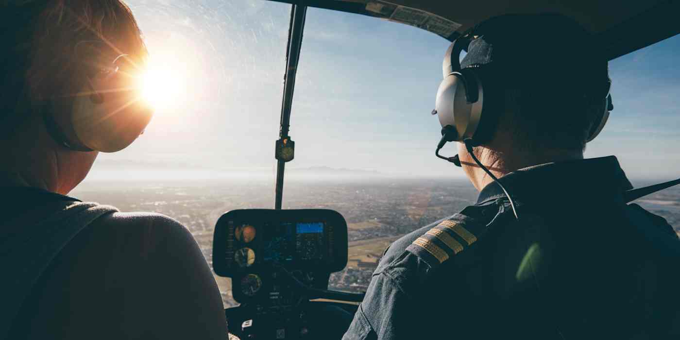 A hero image of two pilots in the cockpit from behind