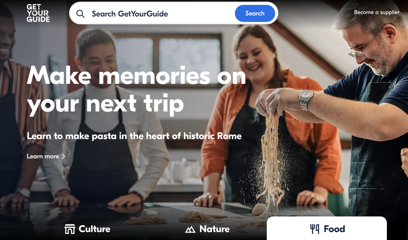 GetYourGuide landing page showing a group of travelers making pasta