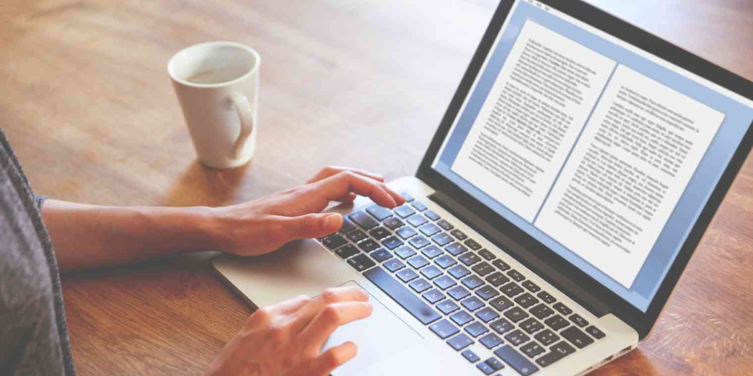 Hero image of someone's hands on a computer, typing a document