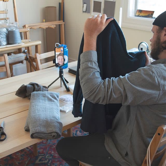 A photo of someone making a video about the sweater