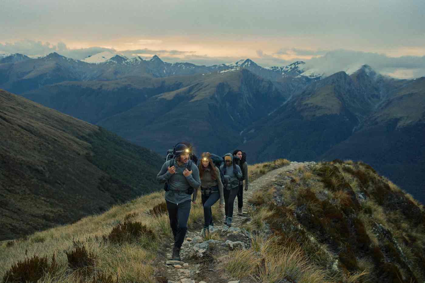 Icebreaker customers wearing outdoor gear on a mountain