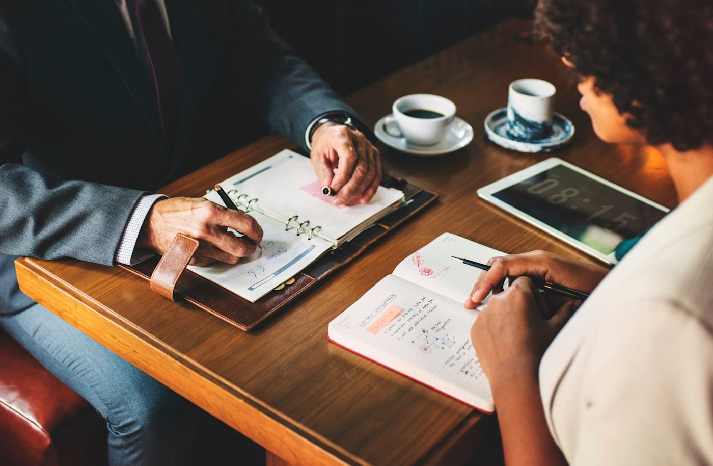 Two people at a table with notebooks