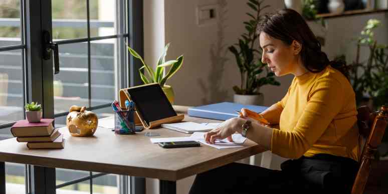 Hero image of a person at a desk writing