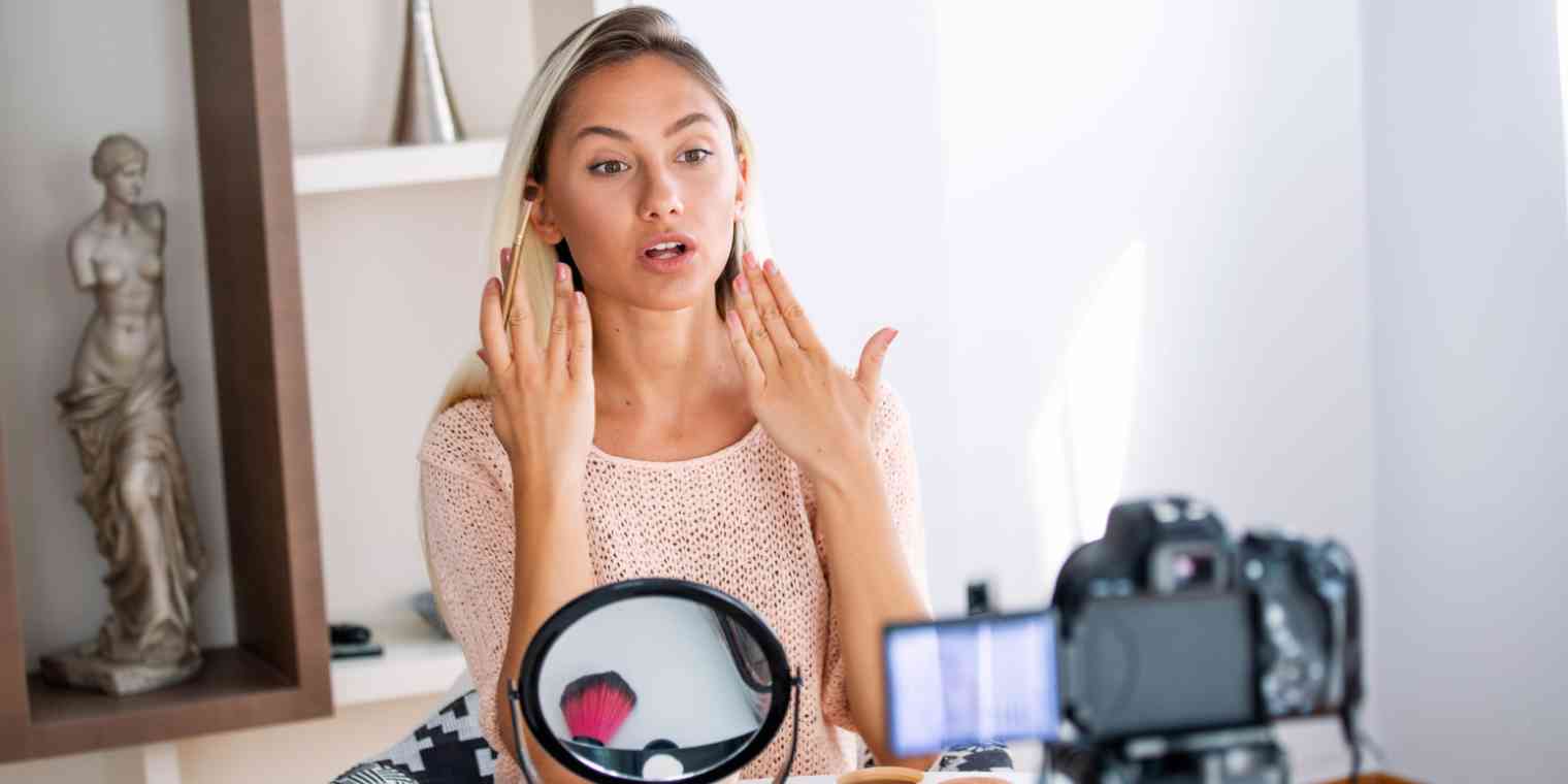 Hero image of a woman doing a makeup tutorial to a camera