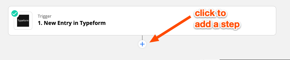 An orange arrow pointing to the plus-sign button