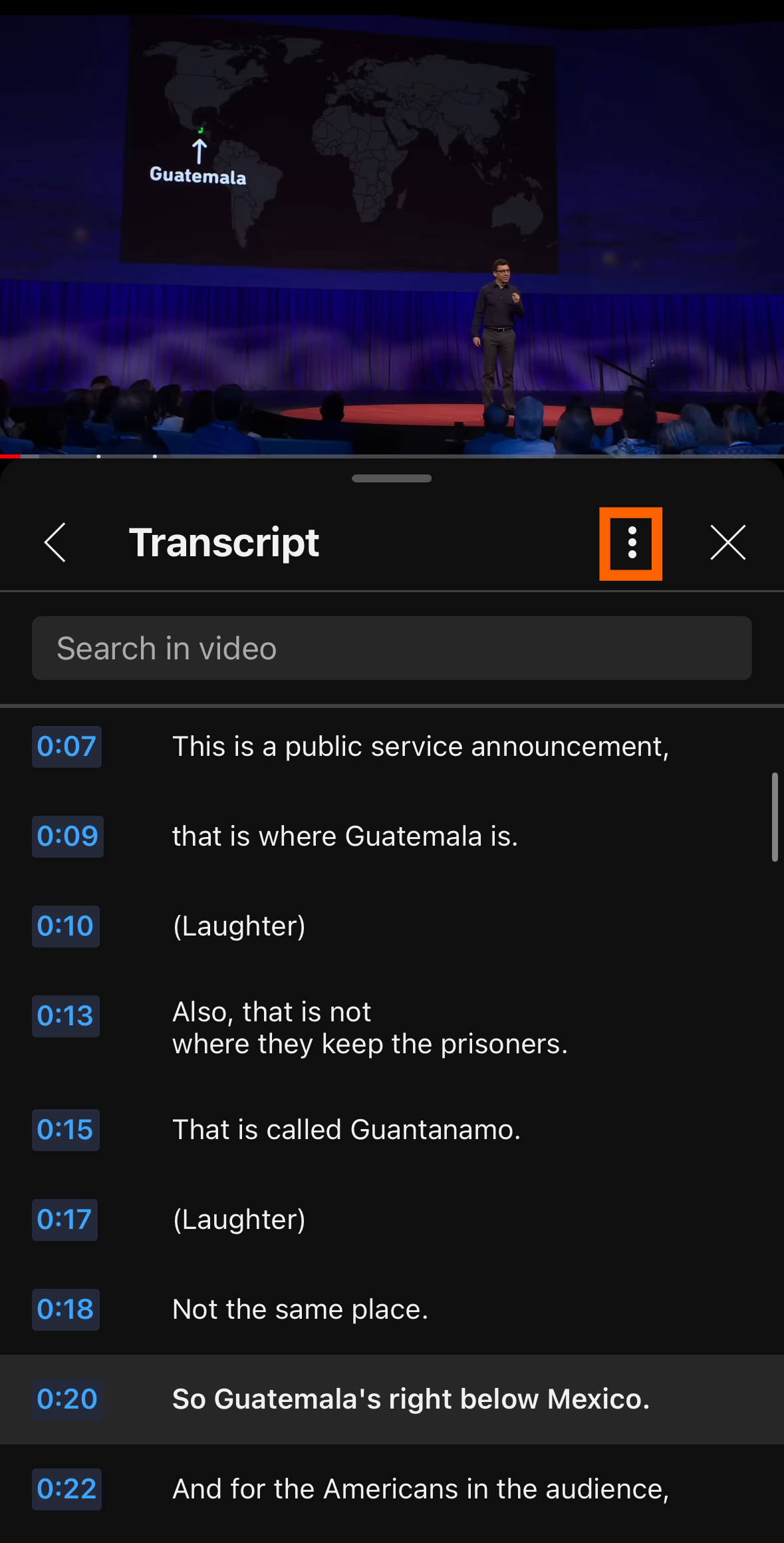 Screenshot of the YouTube video transcript on mobile, with an orange box around the three-dot icon where users can select their preferred language