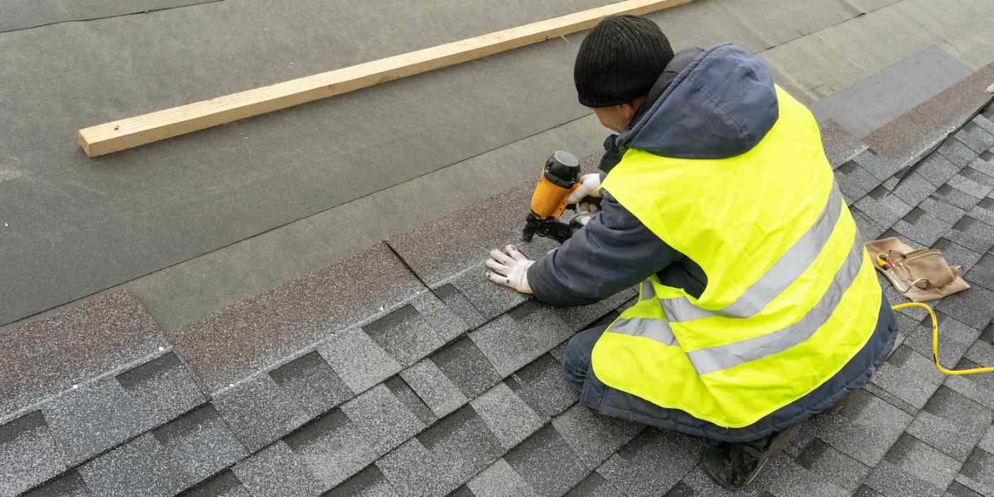 Hero image of a person fixing a roof