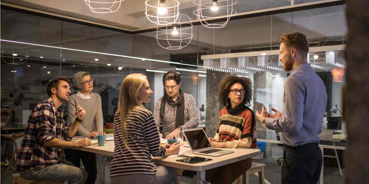 A hero image of a group of people in a modern-looking office