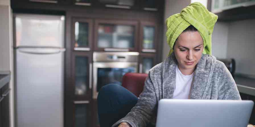 Hero image of a woman working in a bathrobe