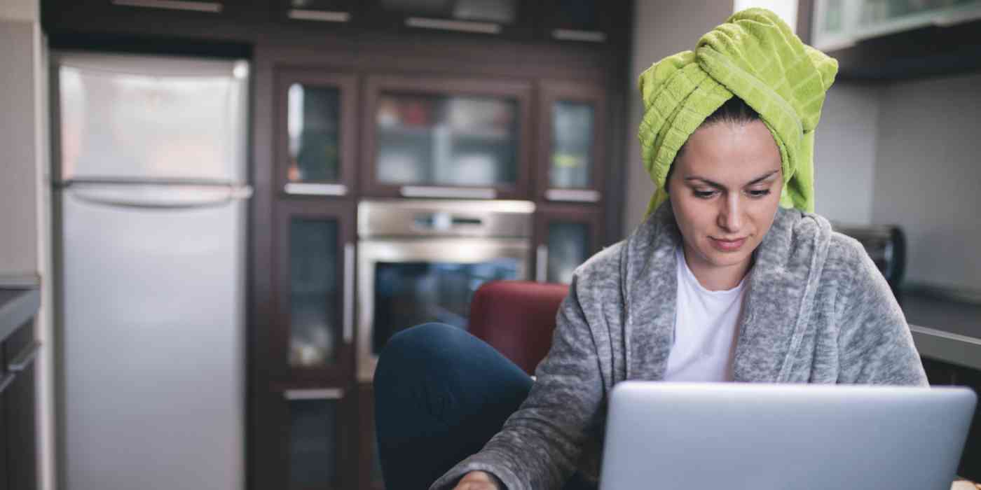 Hero image of a woman working in a bathrobe