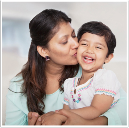 An image of a woman kissing her young child