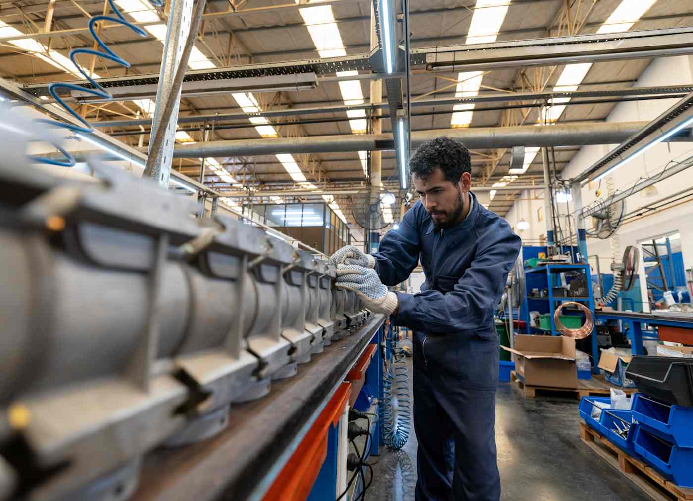 A man works on a manufacturing line.