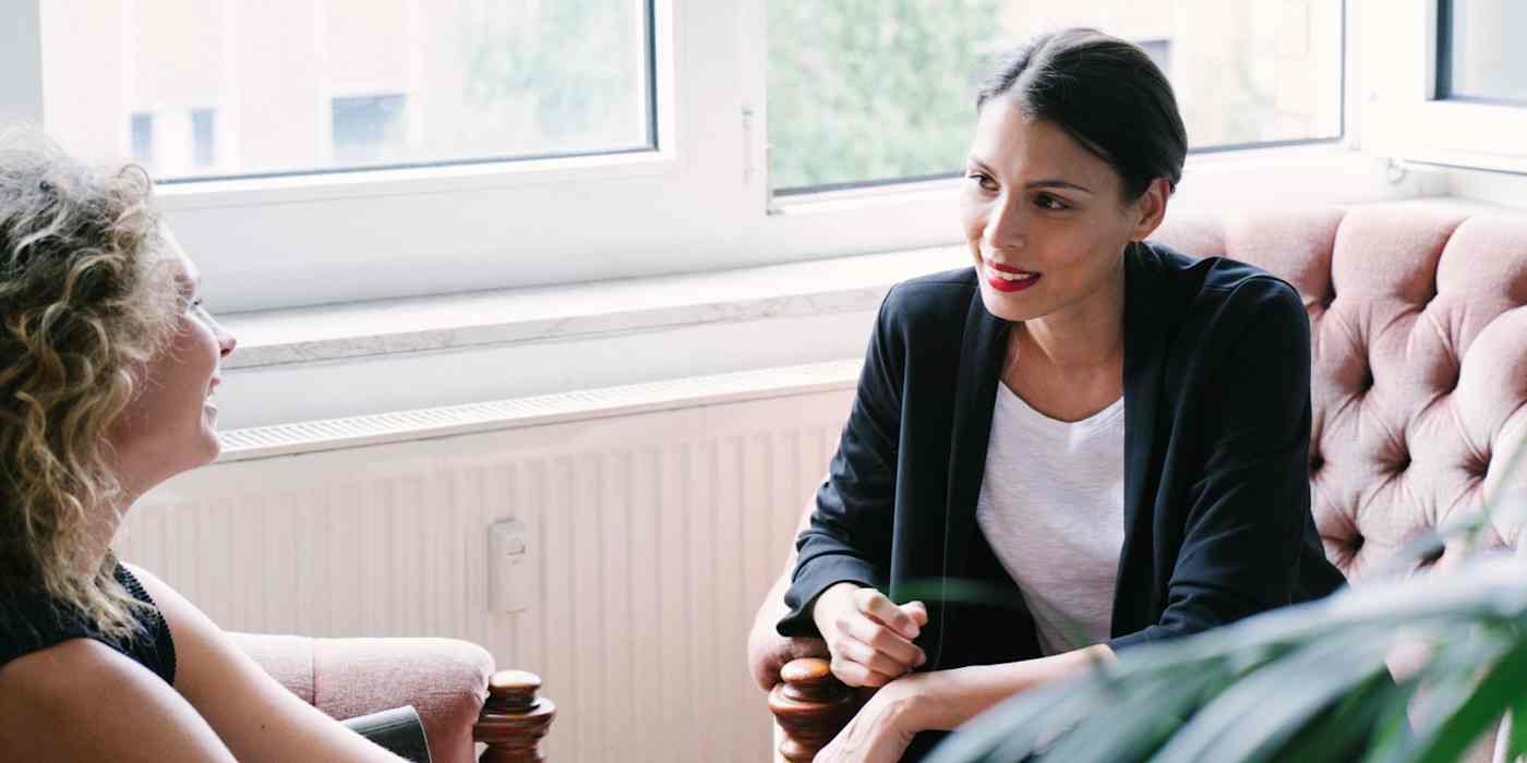 Hero image of two women sitting and talking to each other