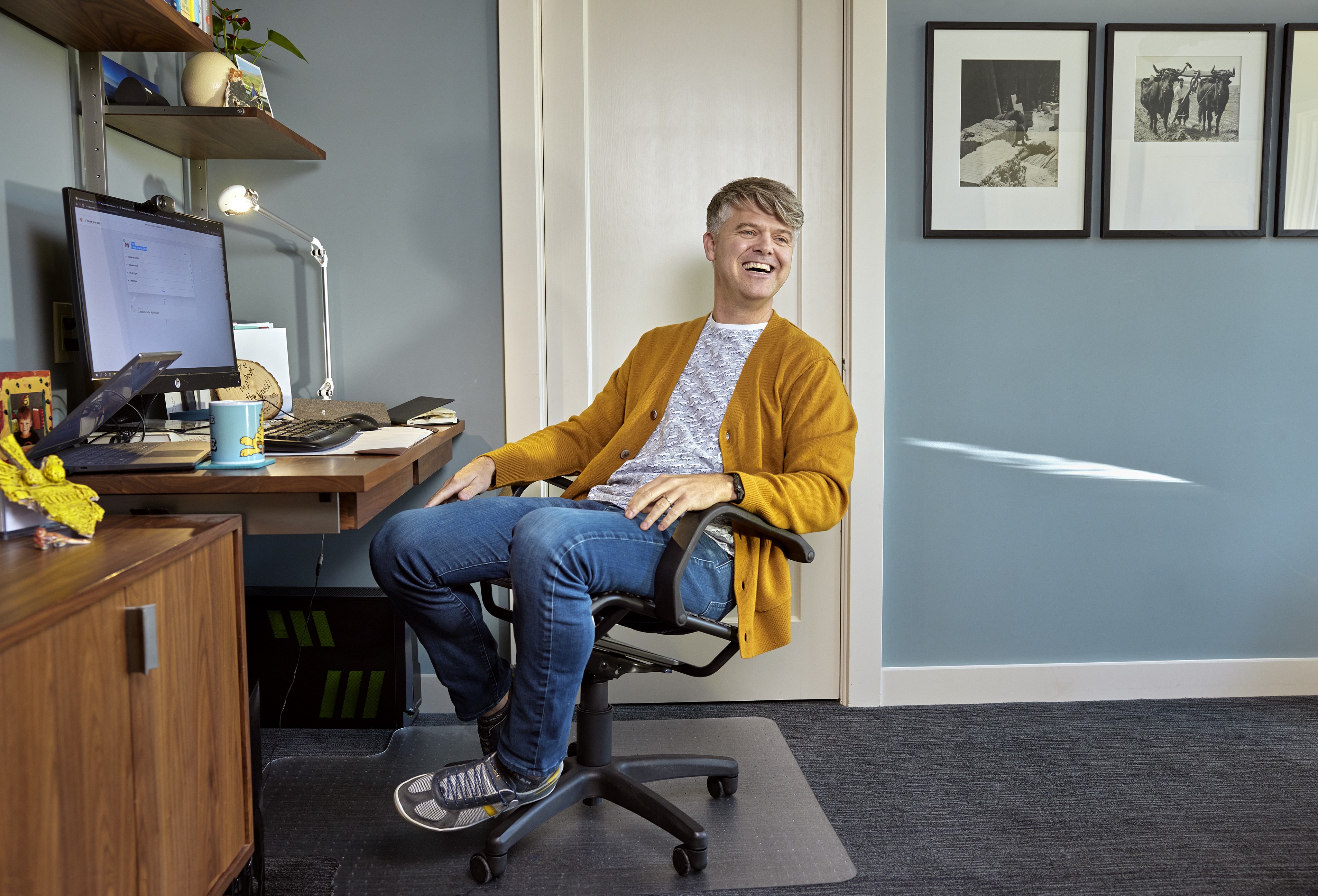 Roborecruiter CEO Chris Collins at his desk, smiling
