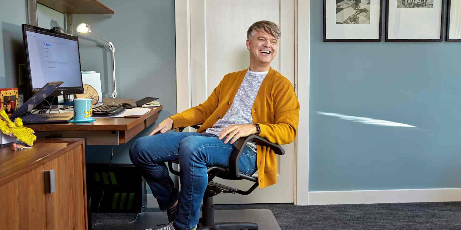 Roborecruiter CEO Chris Collins at his desk, smiling