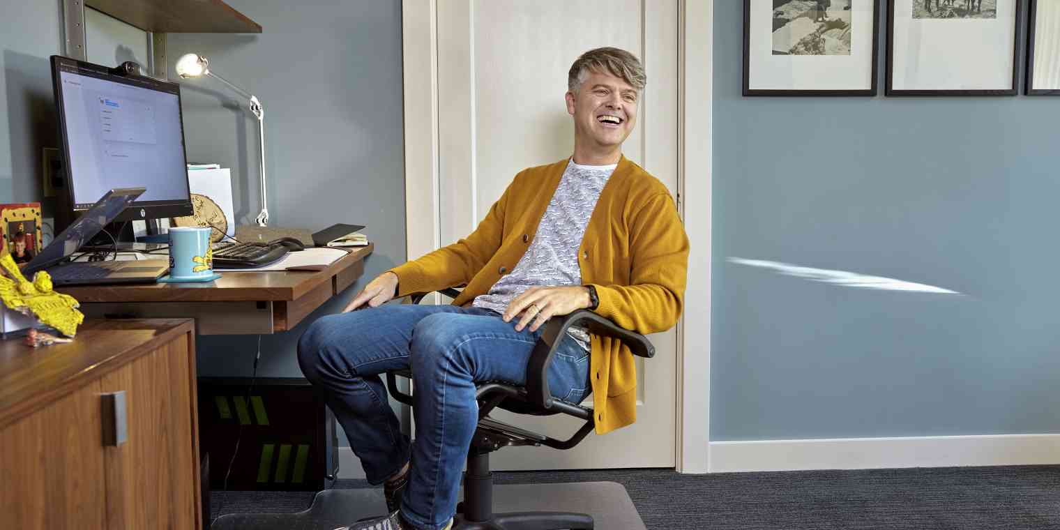 Roborecruiter CEO Chris Collins at his desk, smiling