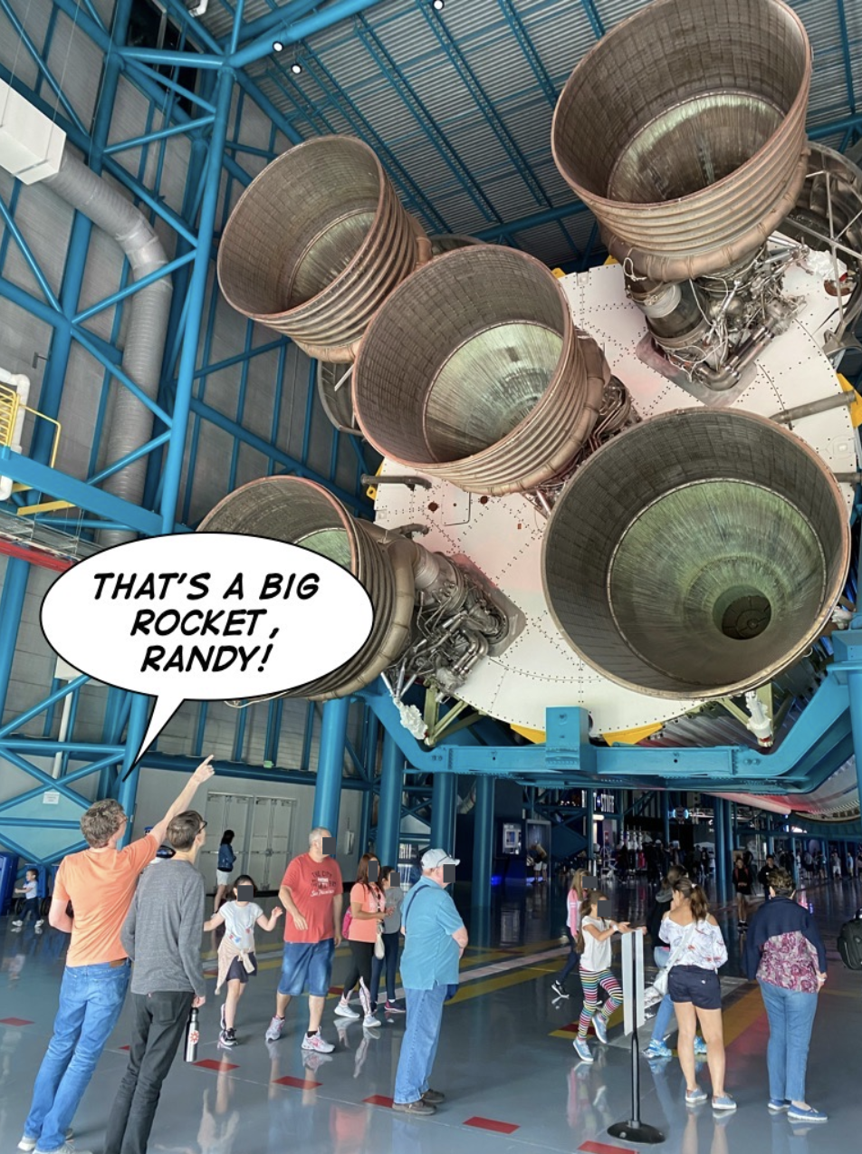 Bryan pointing at a rocket with a speech bubble that says That