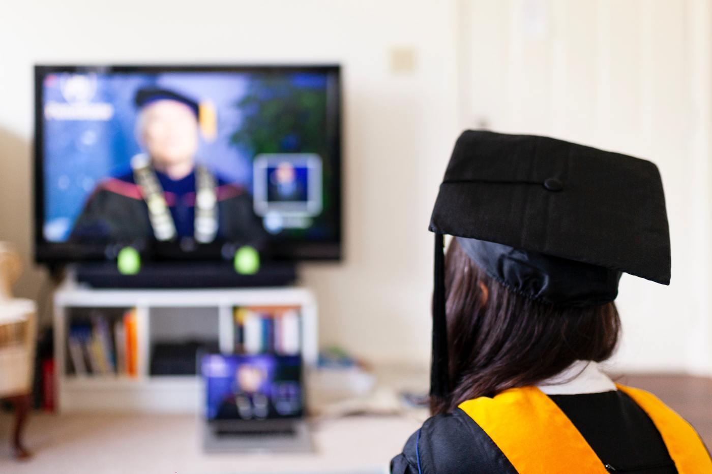 Image of a student watching graduation on TV