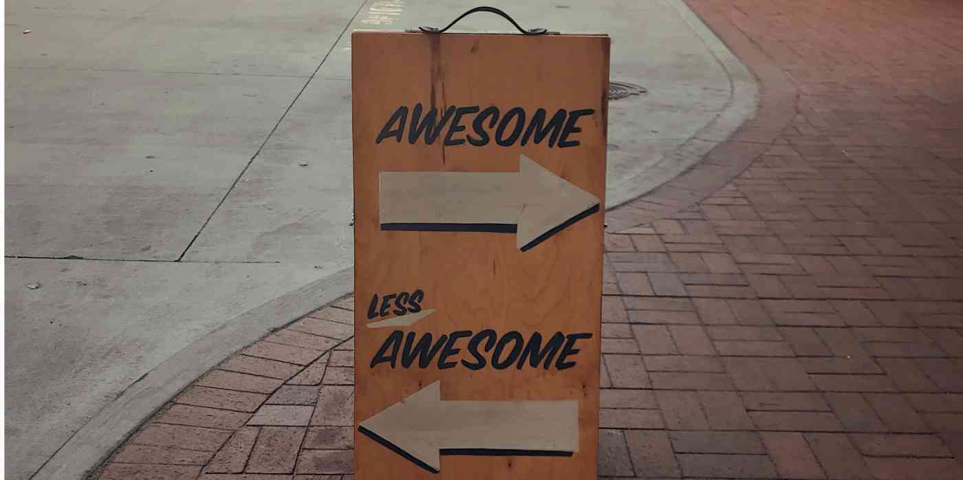 Hero image of a sign that says "Awesome" with an arrow, and "Less Awesome" with an arrow pointing the other direction