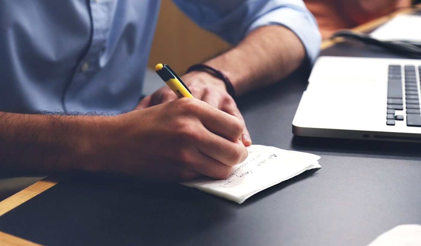 Hand taking notes