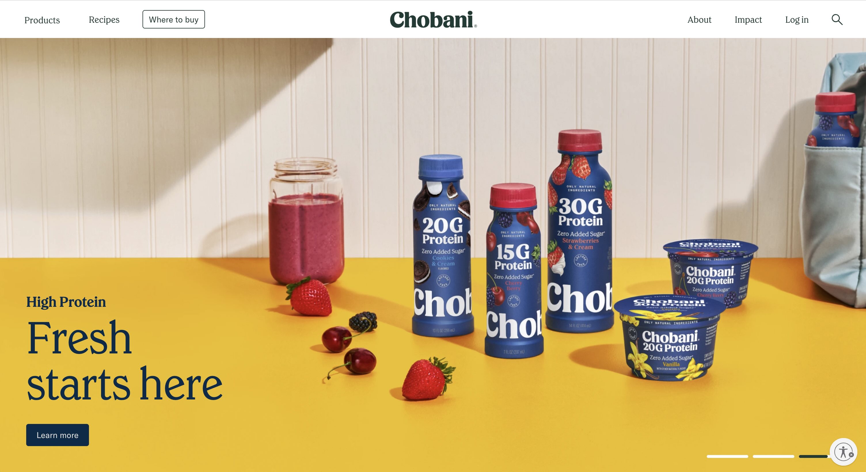 Colorful yellow kitchen backsplash with chobani coffee creamers in front of a vase and flowers in front