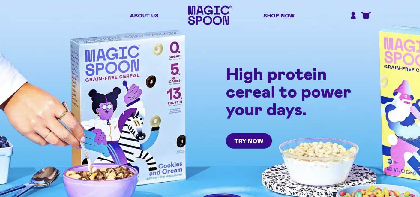 A screenshot of the Magic Spoon website, with a person's hand grabbing a Magic Spoon cereal box, with the text: "High protein cereal to power your days."