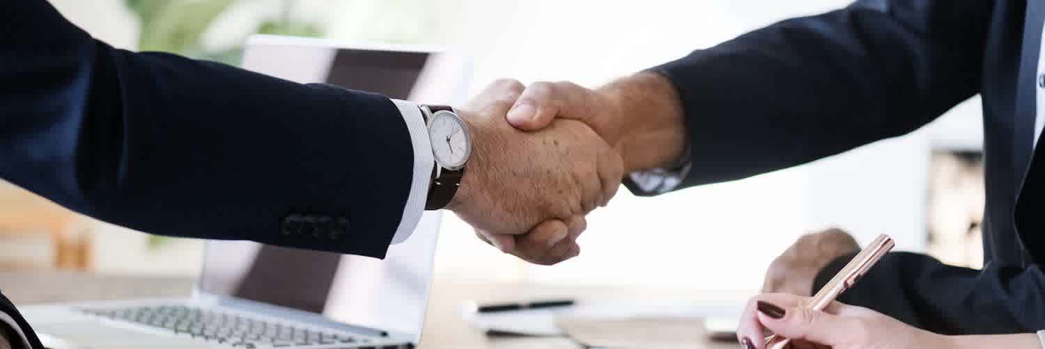Premium Photo  Two happy businessmen shake hands over resume papers entity