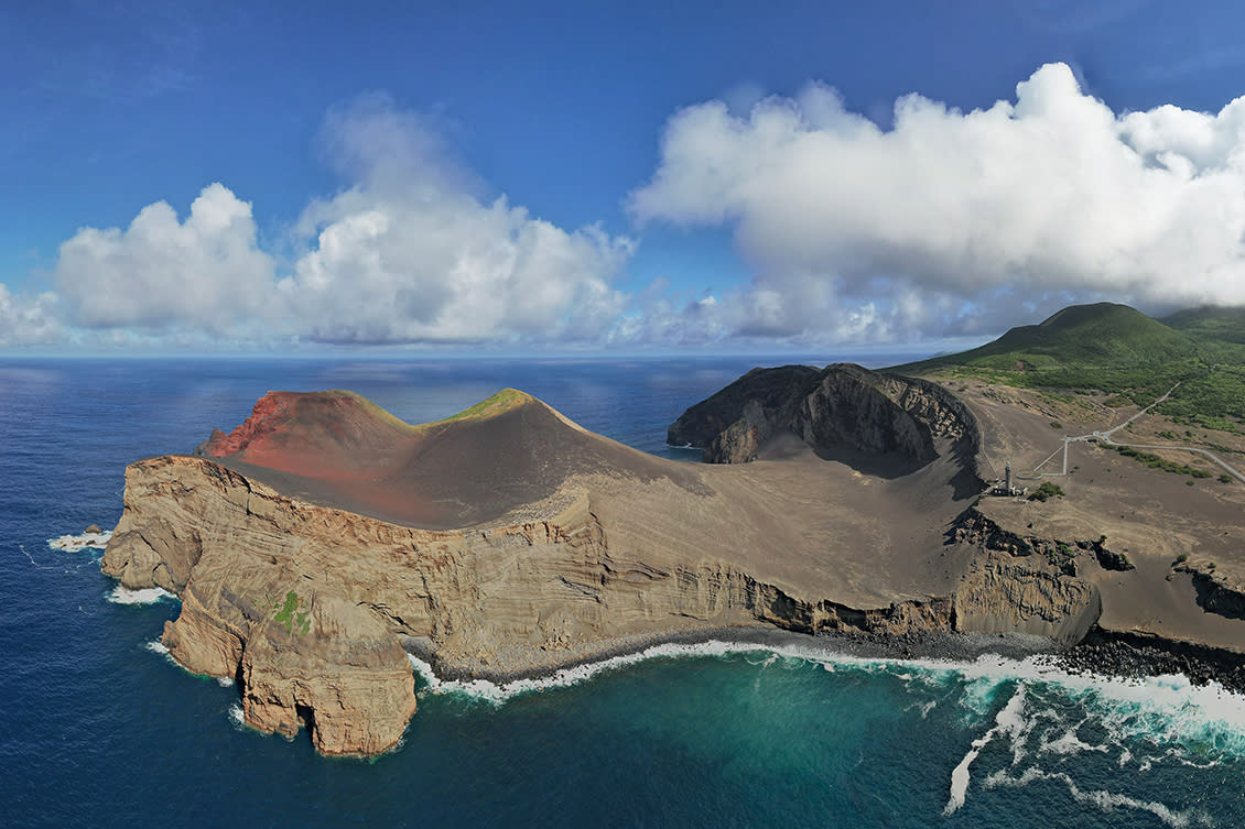 Capelinhos volcano, black ash landscape, lighthouse visible. Faial Island. Daylight. People- no.