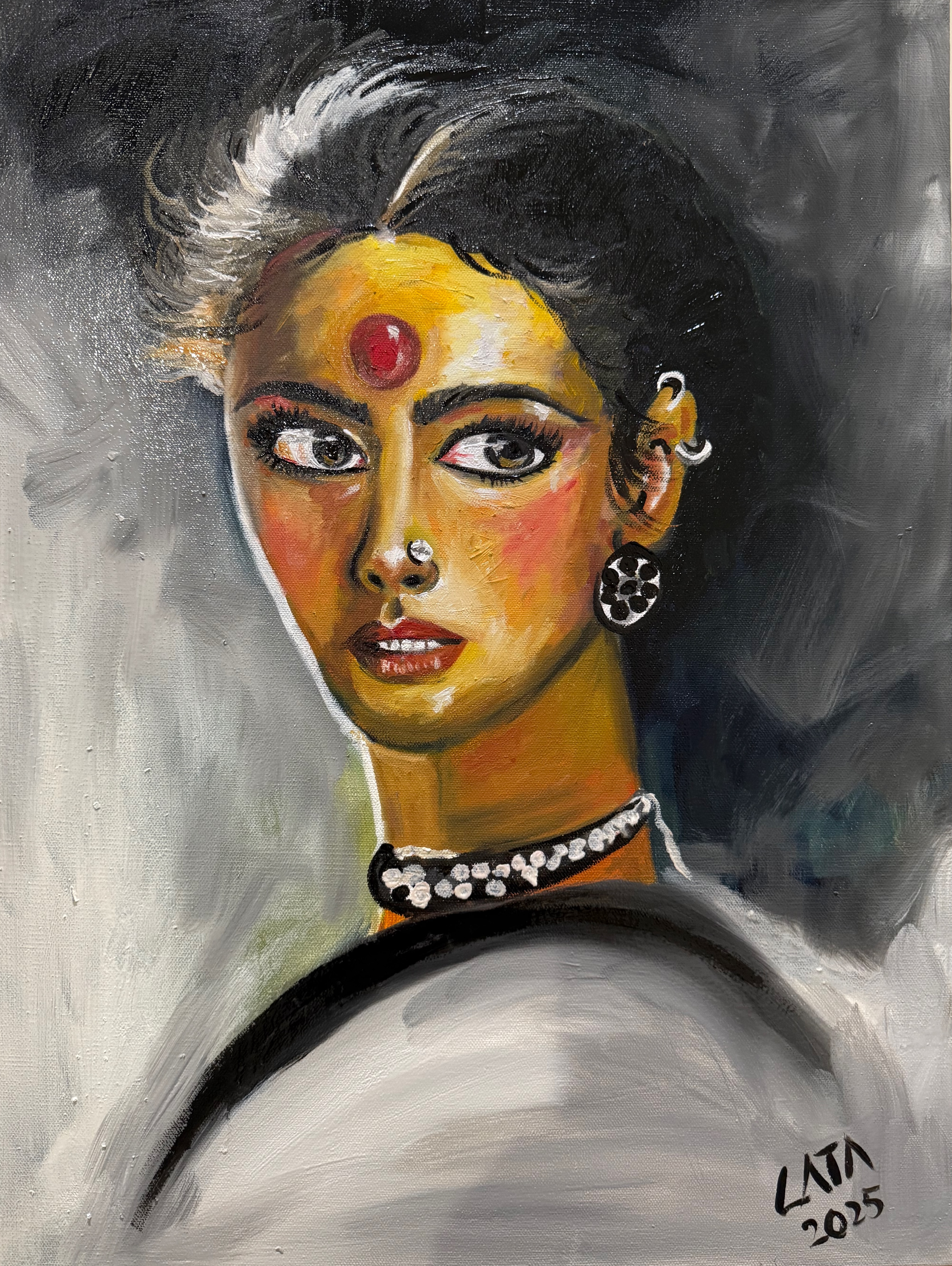 “Defiant” captures the fierce quiet strength of a woman who refuses to be diminished. Painted in rich oils, the portrait radiates intensity through her steady, unblinking gaze — eyes that hold both vulnerability and unshakable resolve. The bold vermillion circle on her forehead becomes a symbol of identity, power, and self-possession, anchoring the composition and drawing the viewer into her world.

Warm ochres, glowing yellows, and deep shadows carve out her face with dramatic contrast, while the expressive brushwork adds movement and emotional tension to the piece. The jewelry — a nose pin, intricate earrings, and a luminous choker — reflects cultural pride, yet her expression transcends place and time.

The swirling monochrome background heightens her presence, as if she is emerging from chaos but entirely undeterred. Her parted lips and lifted chin evoke a woman reclaiming her voice — unafraid, unyielding, and unmistakably herself.

“Defiant” is a tribute to every woman who has ever met the world’s expectations with her own unstoppable truth.