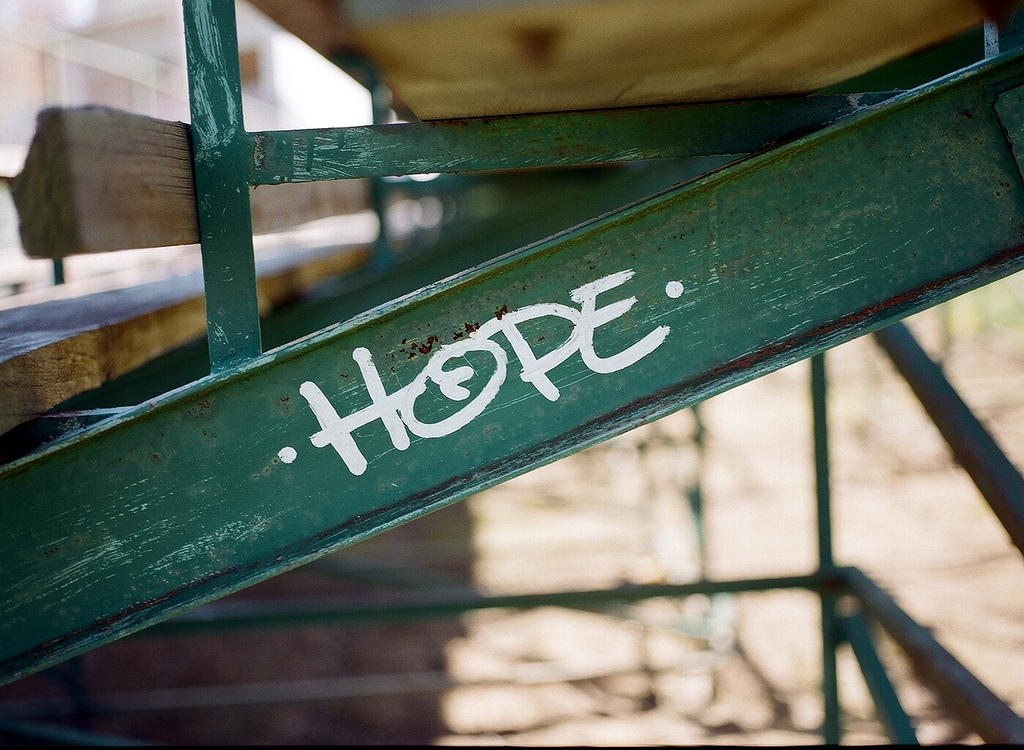A green pole that is holding up wood. It says "Hope"