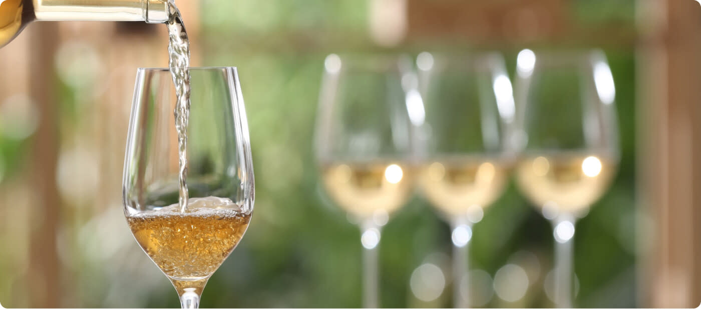 Glasses of Pinot Grigio wine on a blurred background