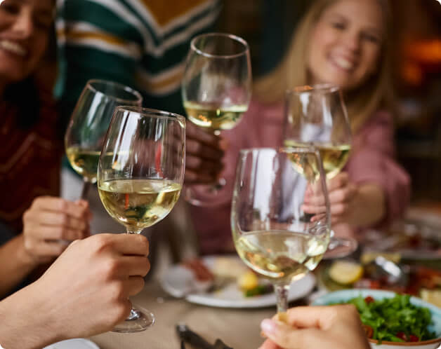 White wine toast at a dinner party