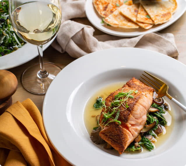 Grilled salmon paired with a glass of Chardonnay wine