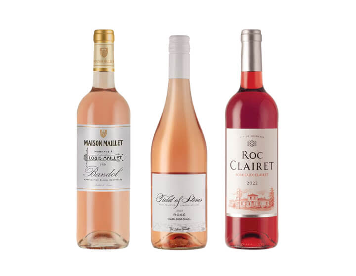 Three bottles of rosé wine on a blank background
