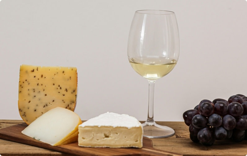 A glass of chardonnay white wine served with cheese