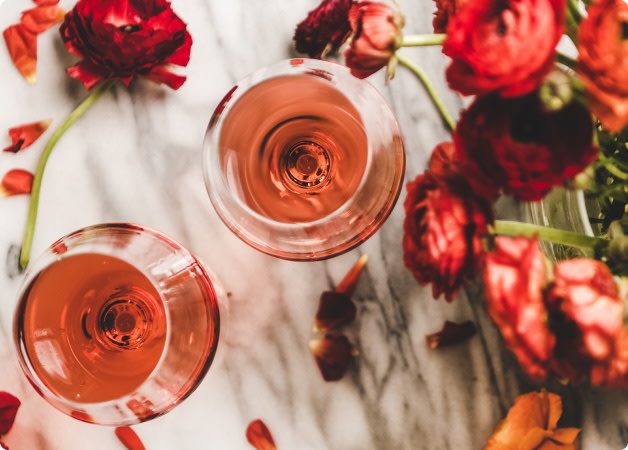 Two glasses of rosé wine with roses, flowers for Valentine's Day